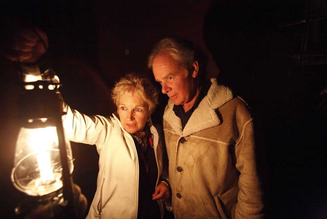 Elderly couple holding light on Ghost Tour