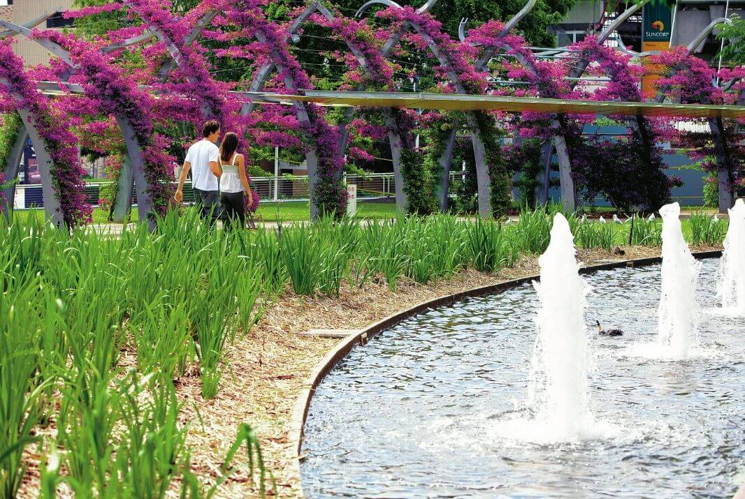 Couple walking through South Bank gardens Brisbane
