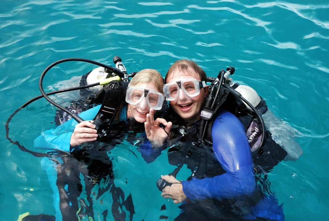 Scuba divers smiling at Michaelmas Cay