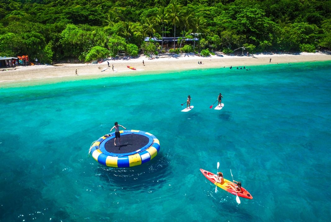 Fitzroy Island Aerial people kayaking at beach