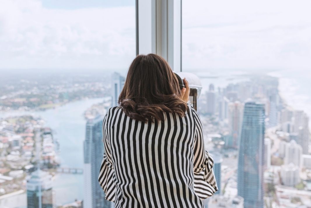 Woman looking through scope at Skypoint Observation Deck Gold Coast