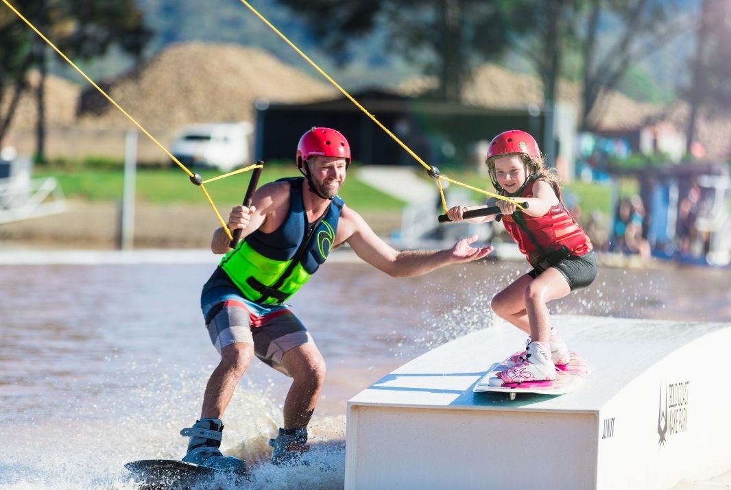 Wakeboarder helping daughter at Gold Coast Wakepark