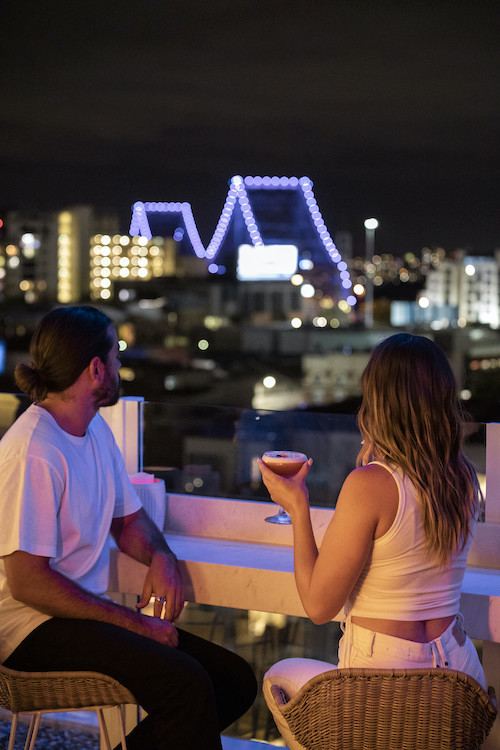Woman enjoying cocktail at Maya Mexican overlooking Brisbane Story Bridge