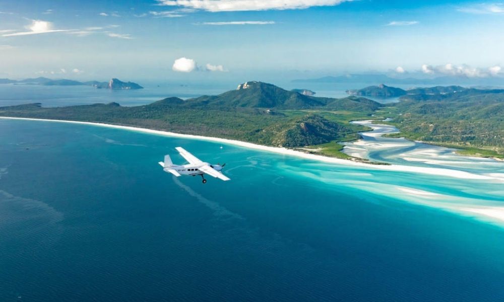 Family jump into the water during a Whitsundays Seaplane Flight