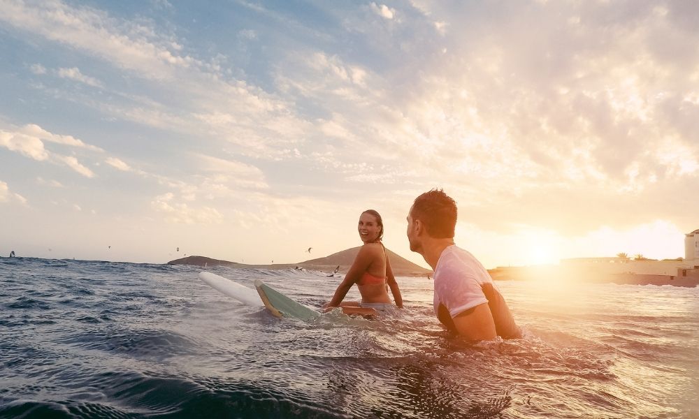 Couple surfing together in the Gold Coast