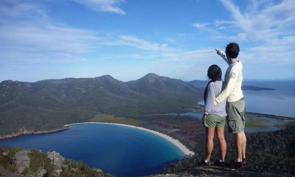 Couple stand at Wineglass Bay Lookout