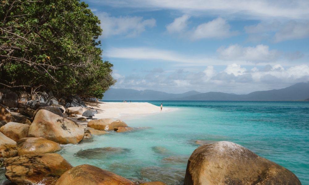 Man walking along Nudey Beach on Fitzroy Island