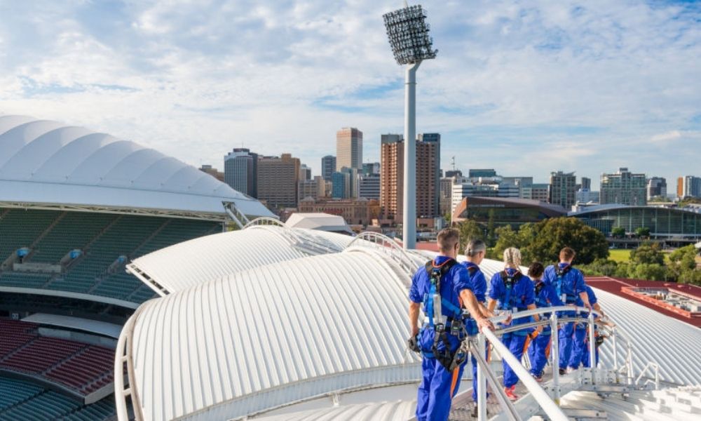 Group climb the Adelaide Oval Roof with views of Adelaide skyline