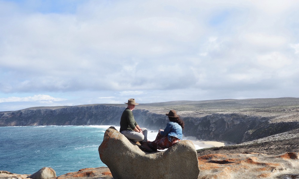 Man and woman admiring ocean views from Remarkable Rocks on Kangaroo Island