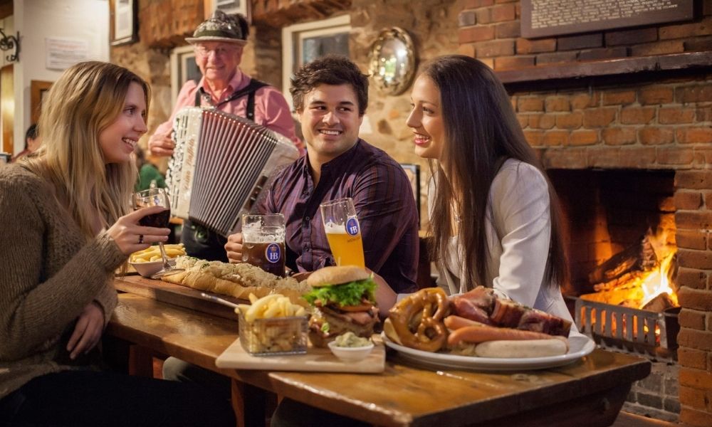 Group of friends dine at a German pub in Hahndorf