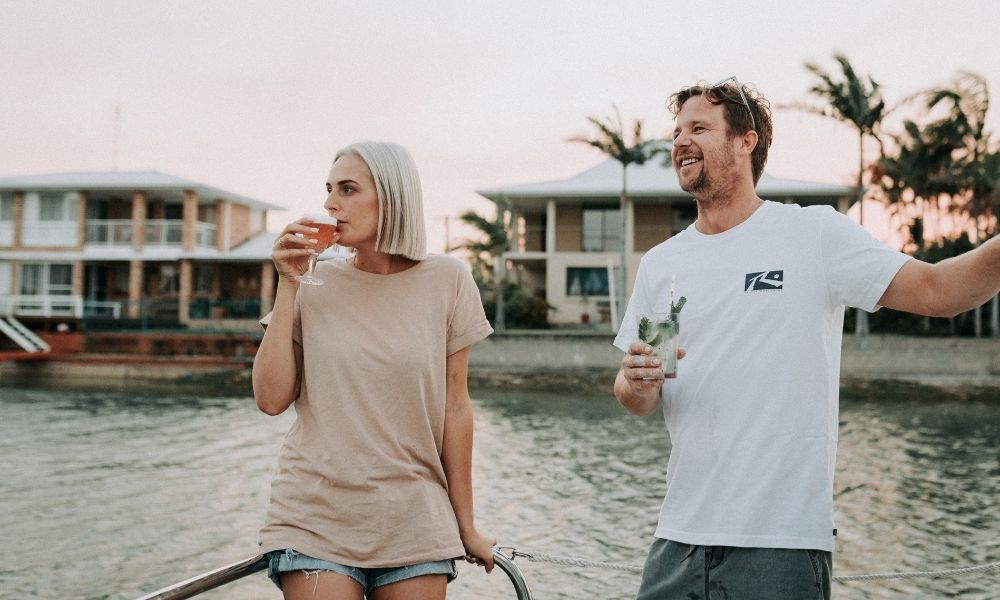 Man and women enjoy a cold drink on a Mooloolaba Sunset Cruise