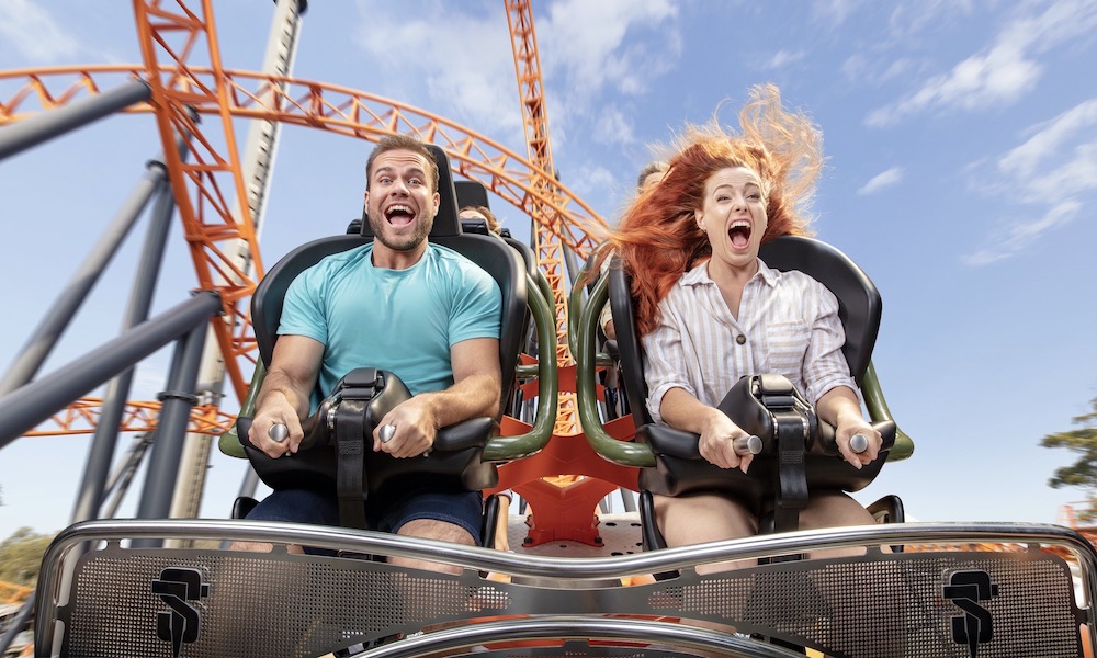 Male and Female riding on Dreamworld Steel Taipan Rollercoaster with the wind in their hair