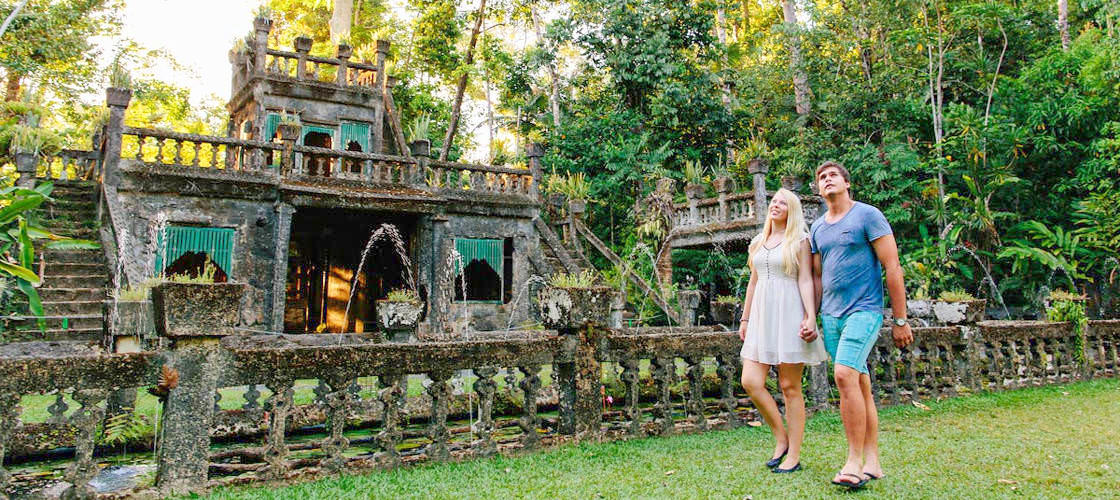 Couple walking through Paronella Park